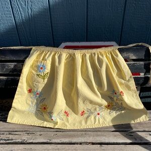 Vintage yellow half apron with embroidered blue, red white flowers tie back